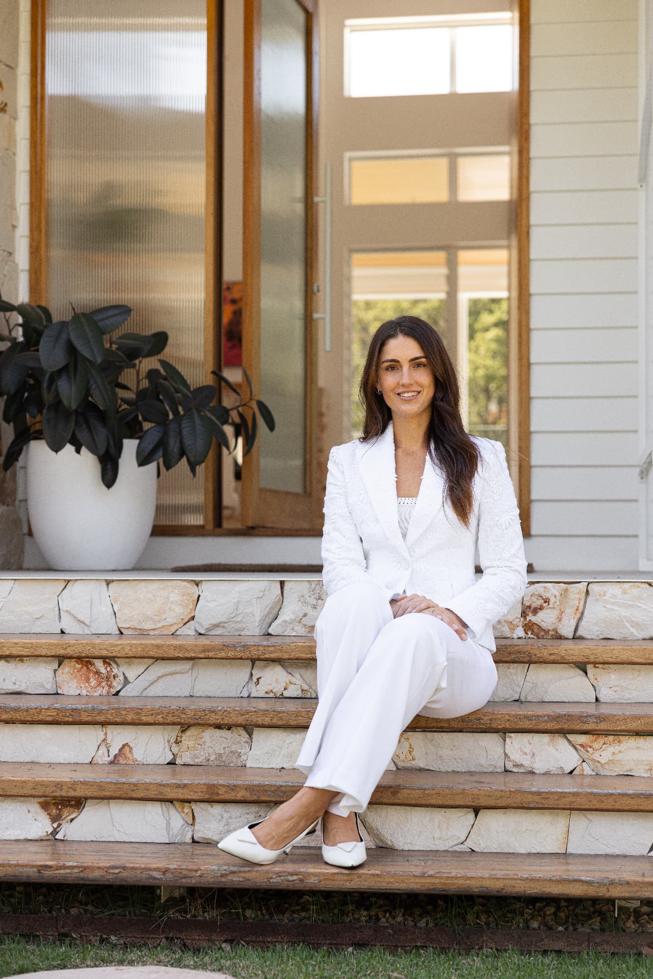 Serena Wilson, Mediterranean nutritionist on the Gold Coast, sitting in warm afternoon light on a Mediterranean style porch