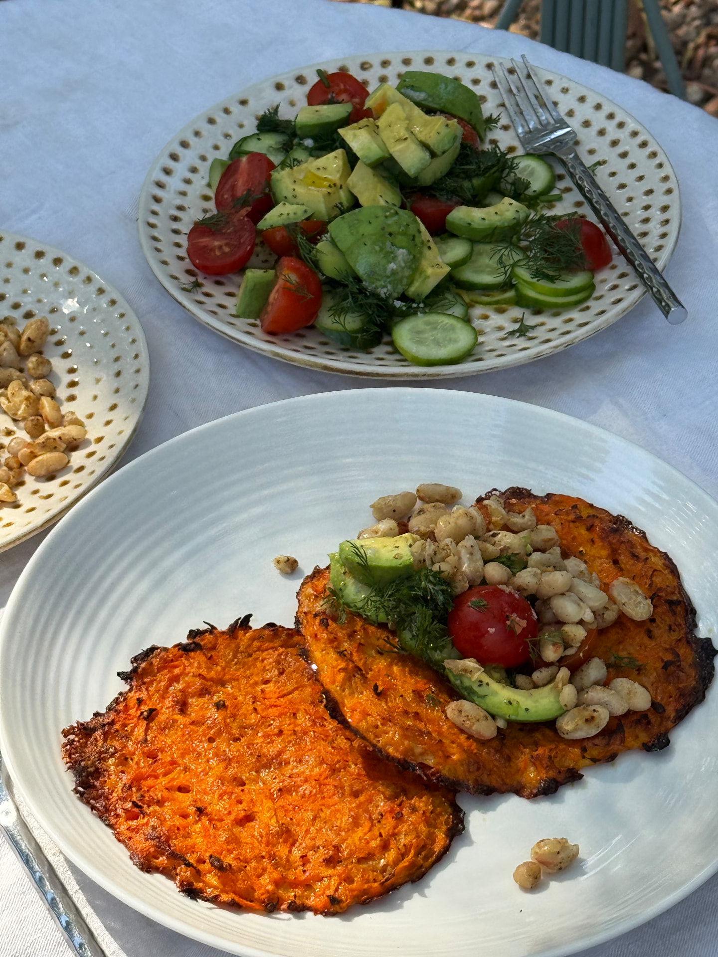 Carrot fritters with avocado, tomato and white beans