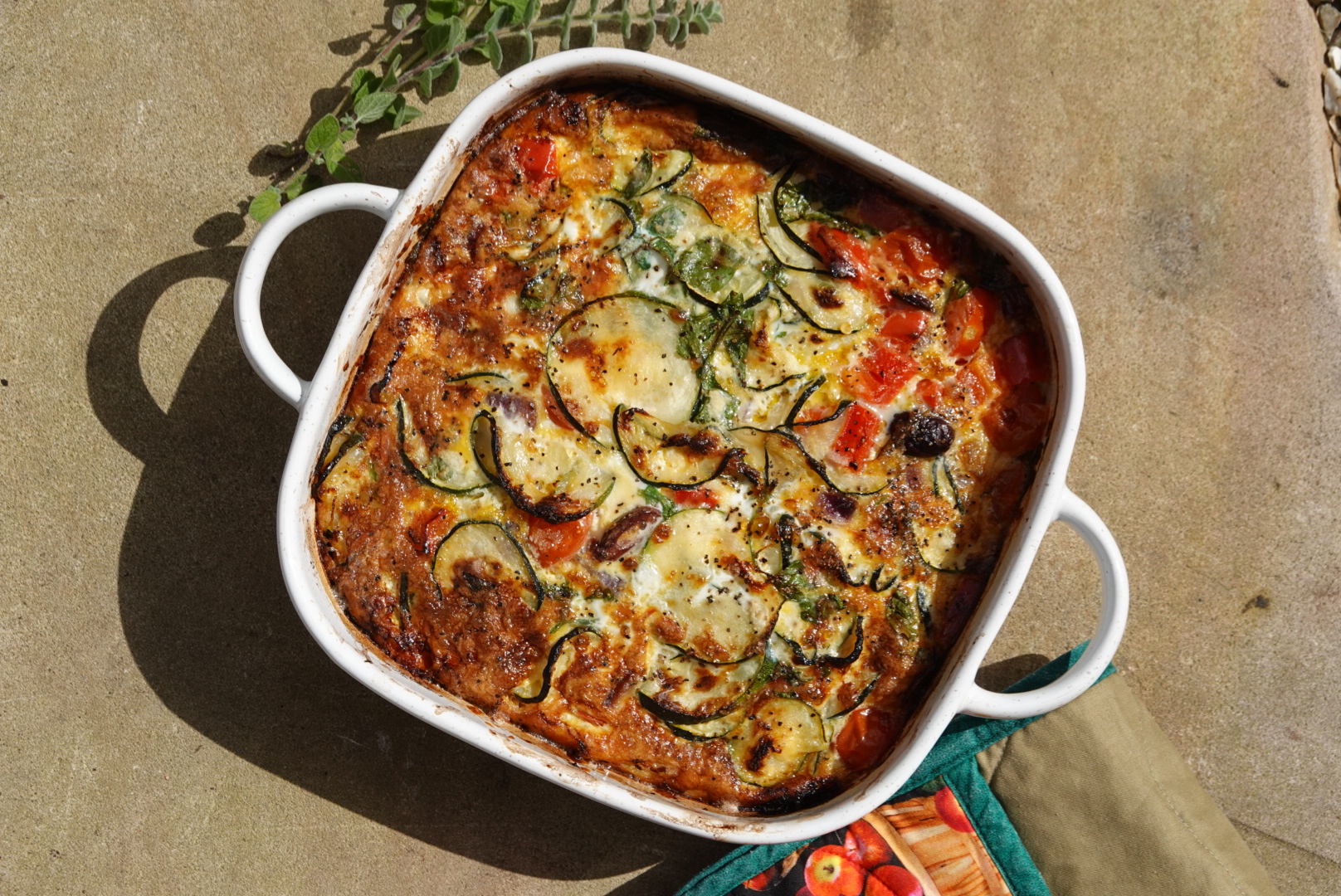 Baked zucchini, tomato and herb dish fresh from the oven, Mediterranean Membership by a Gold Coast nutritionist